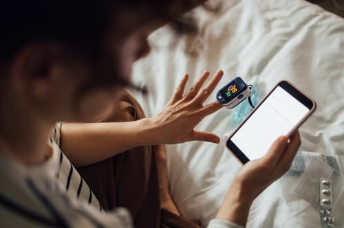 woman using oximeter